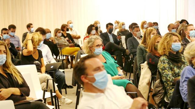 Salle de conférence avec des personnes masquées